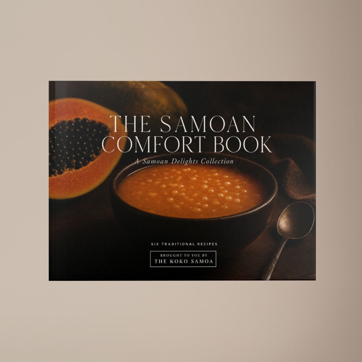 Hardcover keepsake book featuring 6 Samoan recipes, titled "The Samoan Comfort Book,", with vibrant cover art.