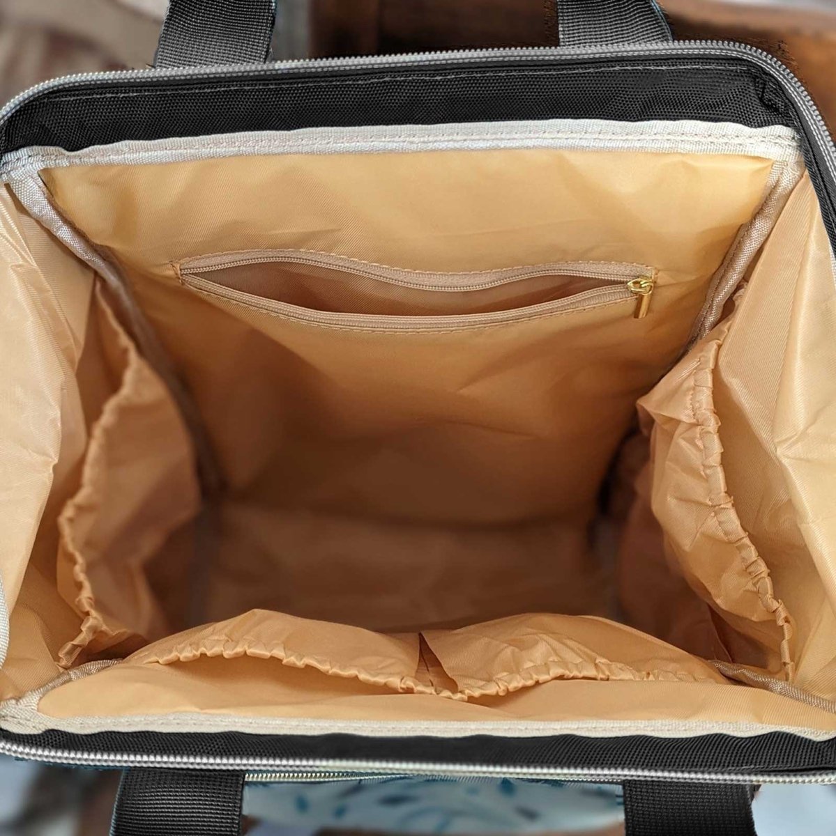 Malu multipurpose diaper bag with multiple compartments and stylish design, suitable for parents on the go.