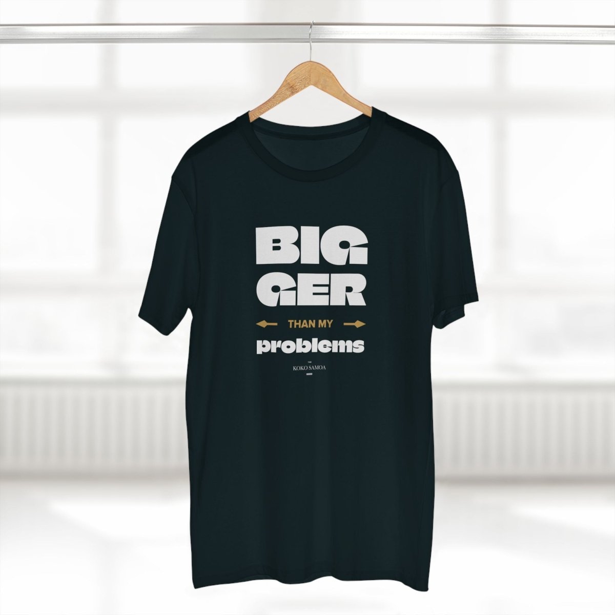Soft unisex T-shirt featuring "Bigger Than Problems" slogan, from The Print Bar, worn by a person showcasing casual style.