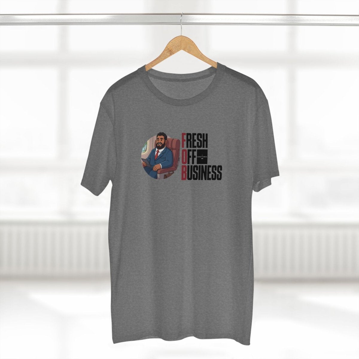 Soft unisex T-shirt by The Print Bar with "Fresh Off Business" graphic, in black, casual fit, worn by a person on a plain background.