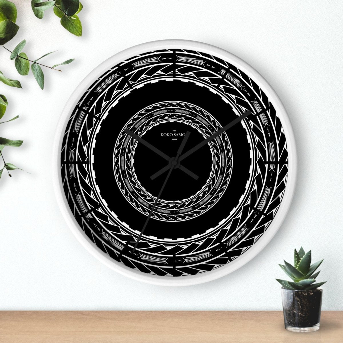 Black 10-inch wall clock with Samoan arrows design, featuring a modern home decor style and black spokes, suitable for AU/NZ/USA regions.