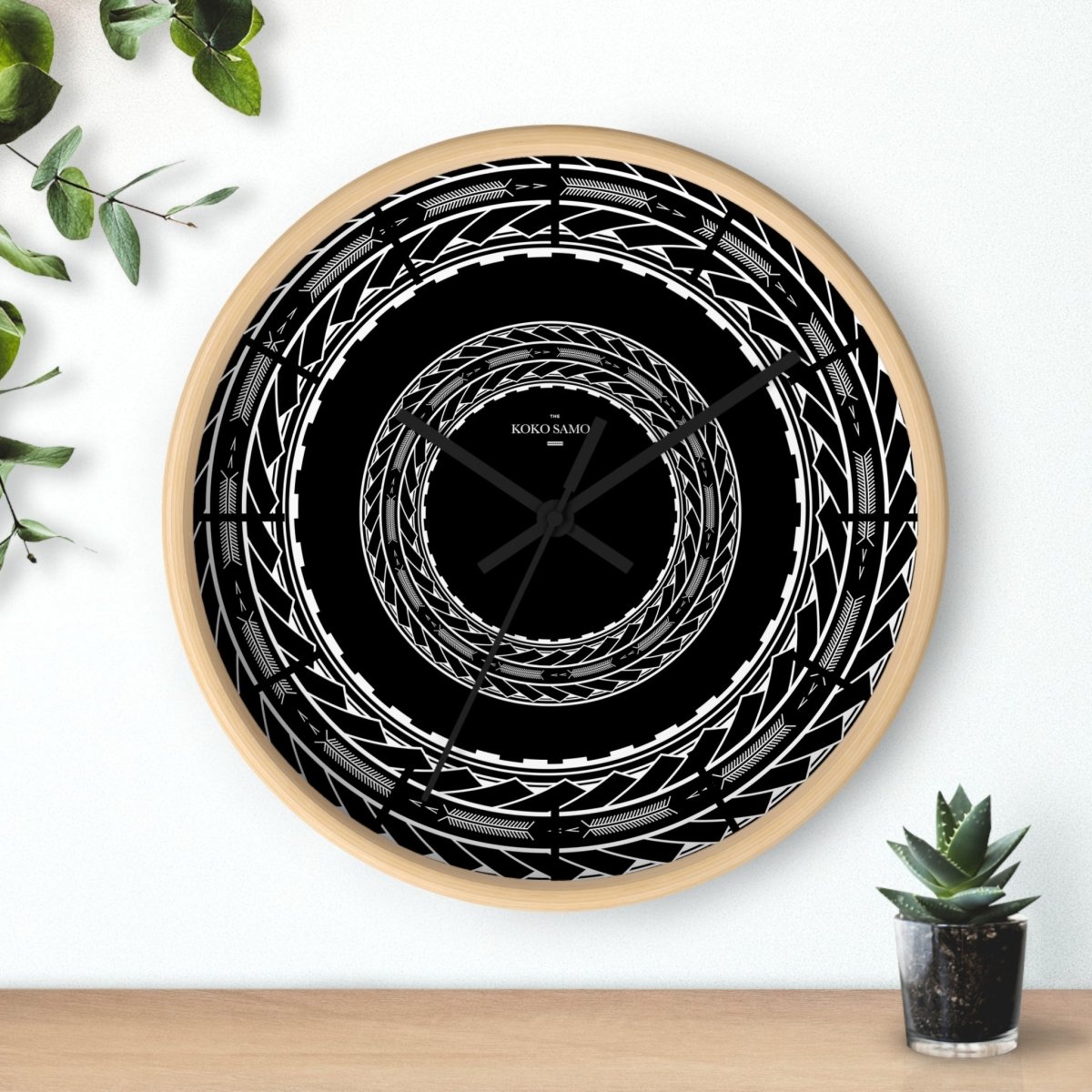 Black 10-inch wall clock with Samoan arrows design, ideal for home decor, featuring a sleek black base and modern style.