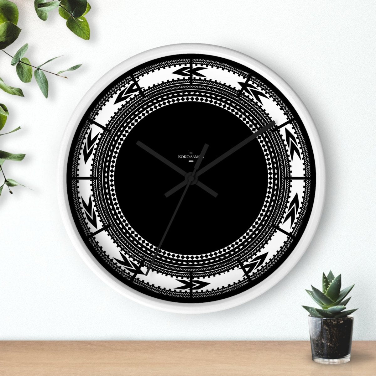 White Pe'a 10-inch wall clock, featuring a modern design with a black base, ideal for home decor.