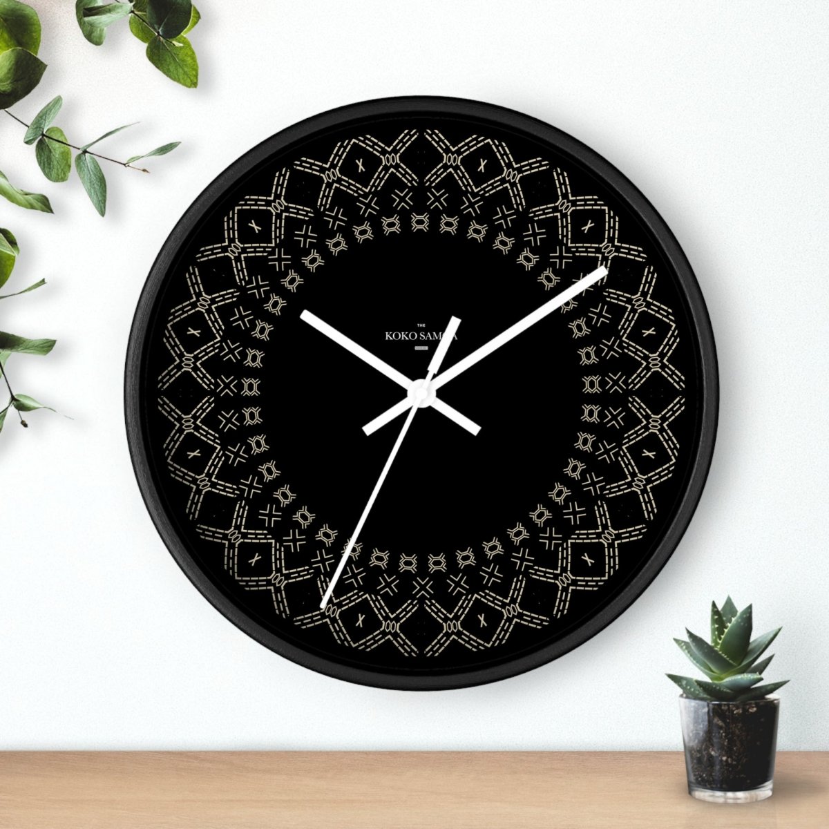 Black and white 10-inch Malu wall clock, featuring a sleek home decor design with a modern spoke style.