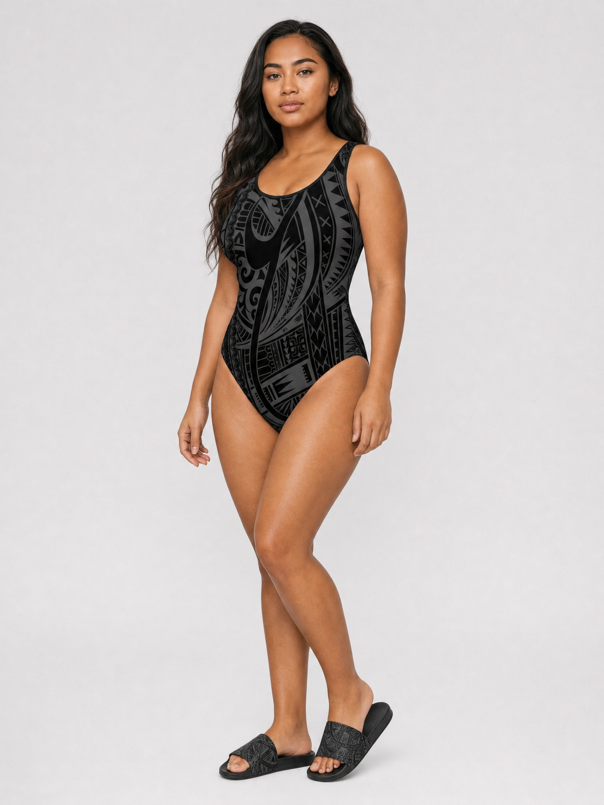 Boxing Day gift set: Women's Classic One-Piece Swimsuit in the Warrior print worn with the matching Women's Slide Sandals.